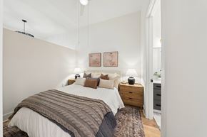 Atlanta apartment for rent - A bedroom with a large bed and a rug on the floor.