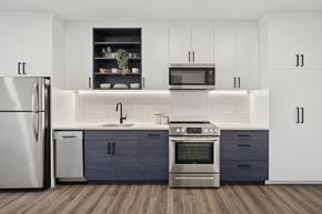 Richmond apartment for rent - A modern kitchen with a stainless steel refrigerator, microwave, oven, and sink.