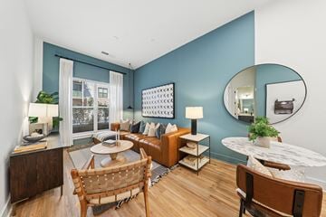 Atlanta apartment for rent - A living room with a brown chair and a white table.