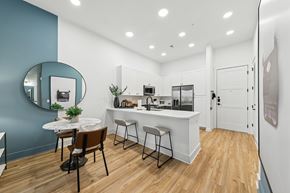 Atlanta apartment for rent - A kitchen with a white counter and a round table with chairs.
