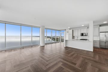 Duluth apartment for rent - A spacious kitchen and living room with a large window overlooking the water.