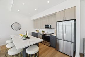 Washington apartment for rent - A modern kitchen with a white table and stools.