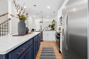 Charlotte townhouse for rent - A modern kitchen with a stainless steel refrigerator and wooden flooring.