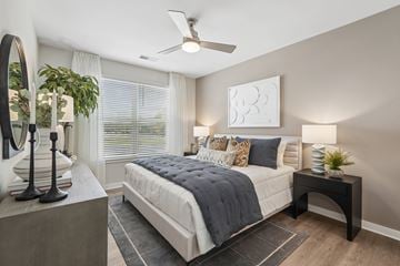 Durham apartment for rent - A bedroom with a large bed and a ceiling fan.