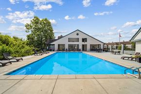 Indianapolis apartment for rent - A large swimming pool in front of a house.