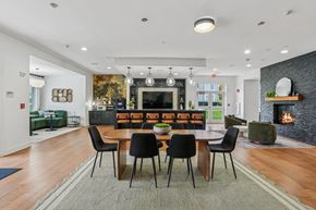 Westborough apartment for rent - A modern dining room with a fireplace and a large table.
