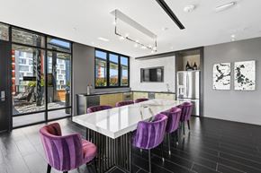 Washington apartment for rent - A modern dining room with purple chairs and a white table.