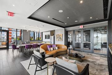 Washington apartment for rent - A modern living room with a grey couch and a coffee table.