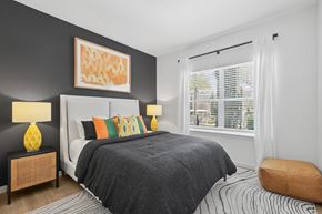 Lutz apartment for rent - A bedroom with a large bed and a painting on the wall.