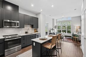 Washington apartment for rent - A modern kitchen with dark cabinets and stainless steel appliances.