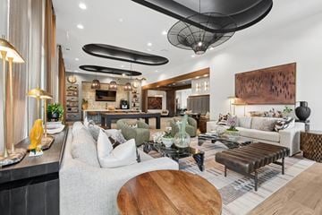 Pooler apartment for rent - A modern living room with a grey sofa, wooden coffee table, and a large painting on the wall.