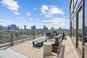 Chicago apartment for rent - A rooftop patio with a bench and a table.