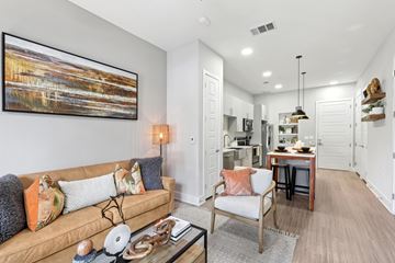 Austin apartment for rent - A living room with a couch, a chair, and a painting on the wall.