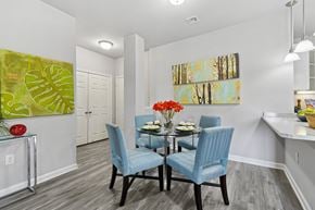 Frederick apartment for rent - A dining room with a table set for two and a painting on the wall.