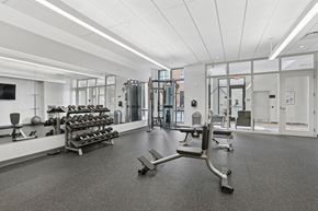 Beverly apartment for rent - A gym with a variety of equipment including weights and machines.