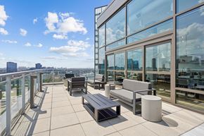 Chicago apartment for rent - A rooftop patio with benches and tables.