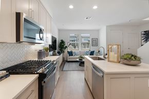 Chula Vista apartment for rent - A modern kitchen with a black stove top oven and a white counter top.