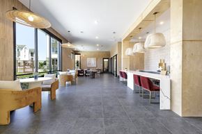 Pflugerville apartment for rent - A modern dining area with a long table and chairs.
