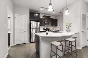 Austin apartment for rent - a kitchen with a large island with two stools