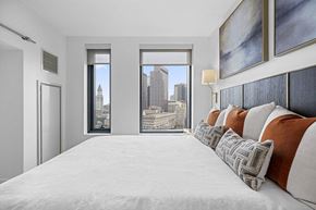 Boston apartment for rent - a bedroom with a large bed and a city view