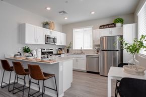 Peoria apartment for rent - a kitchen with white cabinets and stainless steel appliances