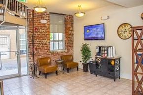Richmond apartment for rent - A room with a brick wall and a flat screen TV mounted on the wall.
