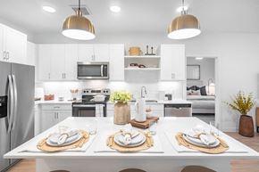 Georgetown apartment for rent - A modern kitchen with a dining table set for two.