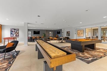Milton townhouse for rent - A modern living room with a long wooden table in the center.