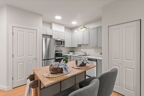 Milton townhouse for rent - A modern kitchen with a dining table set for two.