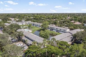 Naples townhouse for rent - A bird's eye view of a resort with a swimming pool and a parking lot.