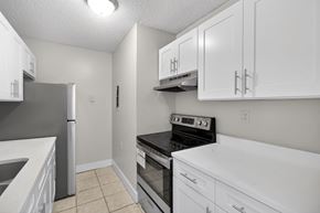 West Palm Beach apartment for rent - A kitchen with white cabinets and appliances.