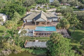 Ft. Myers apartment for rent - A house with a pool surrounded by trees.A house with a pool surrounded by trees. at Cascades at Clear Lake Apartments, Florida, 33908