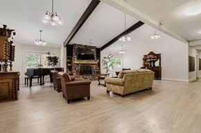 Portland apartment for rent - A living room with a piano, a couch, and a chair.