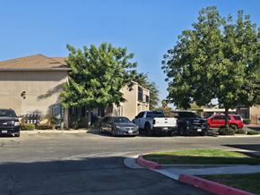 Mendota apartment for rent - A black car is parked in front of a house.