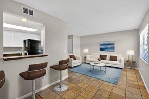 Naples townhouse for rent - A living room with a bar area and a couch.
