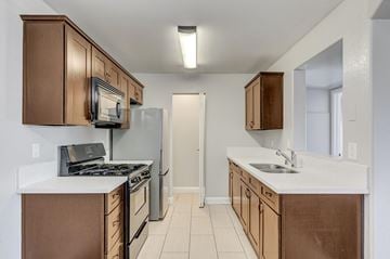Henderson apartment for rent - A kitchen with brown cabinets and white countertops.