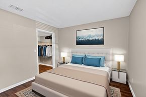 Naples townhouse for rent - A bedroom with a large bed and a painting on the wall.