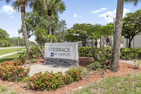 Naples townhouse for rent - A sign that says Terrace at Naples in front of some trees.