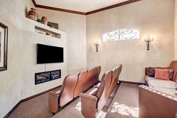 Las Vegas apartment for rent - A living room with a fireplace and a row of chairs.