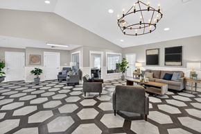 Ft. Myers apartment for rent - A spacious living room with a patterned floor and a chandelier. at Cascades at Clear Lake Apartments, Florida, 33908