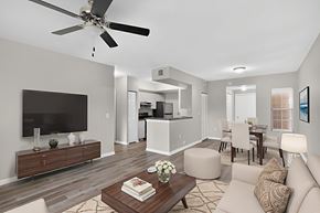 Miramar apartment for rent - A modern living room with a flat screen TV, a coffee table, and a ceiling fan.