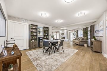 San Diego apartment for rent - A well-lit living room with a dining table and chairs in the center.