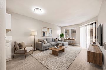 San Diego apartment for rent - A living room with a grey couch, a wooden coffee table, and a flat screen TV mounted on the wall.