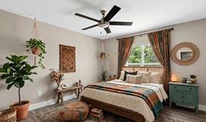 Lehigh Acres triplex for rent - A bedroom with a bed, a ceiling fan, and a window with curtains.