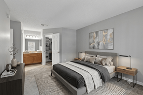 Oldsmar apartment for rent - A bedroom with a large bed and a painting on the wall.