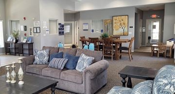 Corcoran apartment for rent - A living room with a grey couch and a coffee table.