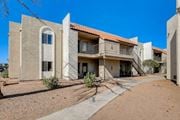 Las Vegas apartment for rent - A building with a red tile roof and a balcony.
