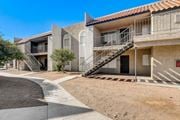 Las Vegas apartment for rent - A building with a red tile roof and a staircase with a metal railing.