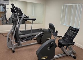 Huron apartment for rent - A gym with a treadmill, elliptical trainer and a stationary bike.