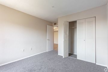 Riverview apartment for rent - an empty bedroom with closet doors and carpeting